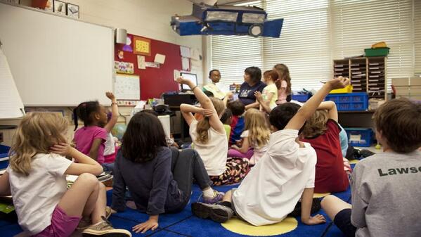 Teacher Assistant helping students in the classroom 
