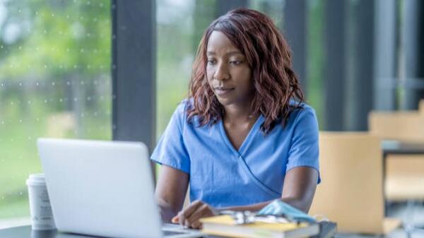 A Life College nursing student studying on her laptop