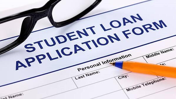 A student loan application with a pair of glasses and a pen on top of it