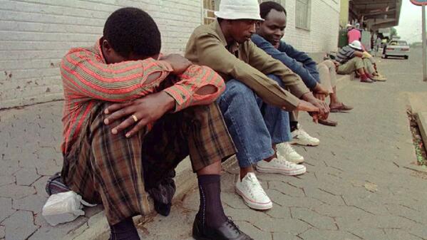 Job seekers waiting on roadside for employment