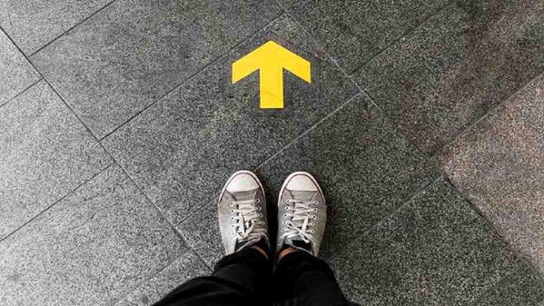 iie student's feet in front of an arrow pointing upwards