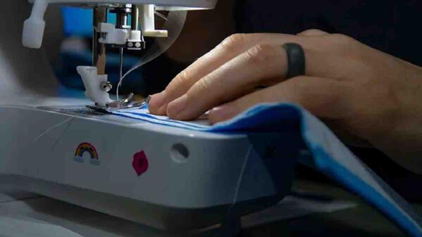 person sewing in a sewing class