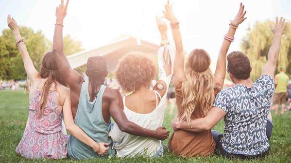 group of friends sitting on the lawn