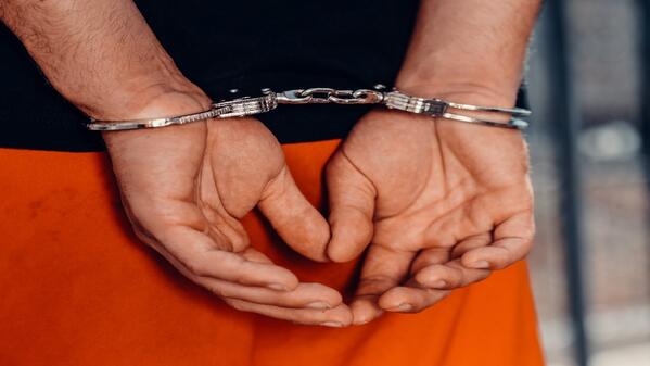person in handcuffs
