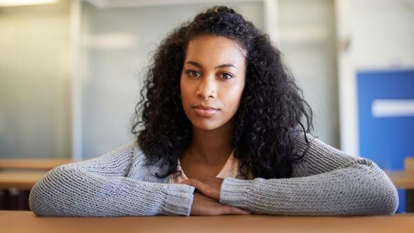 lady sitting with arms on desk