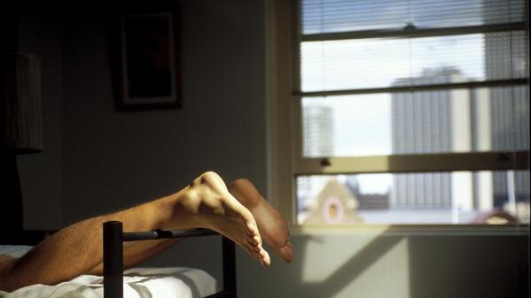 student laying on a single bed