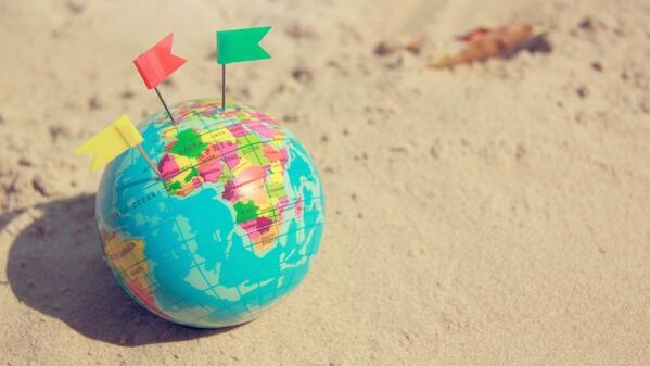 world globe on beach sand